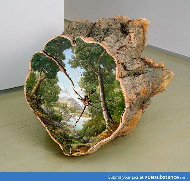 Landscape painted on the surface of a cut log