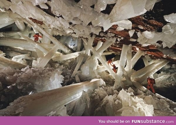 Scientists climbing over the world's largest natural crystals