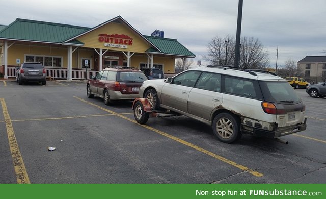 An Outback pulling an Outback, stopped to eat at Outback, parked outback