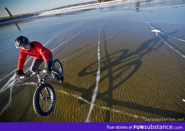 Winter cycling on crystal clear frozen Lake Michigan