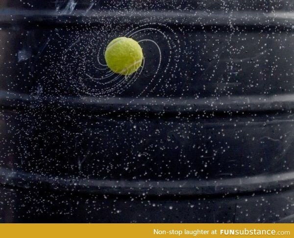 Wet spinning tennis ball