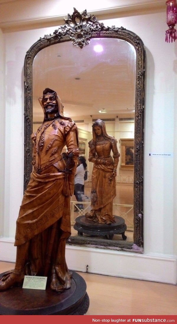 A mirror is needed to fully appreciate this statue