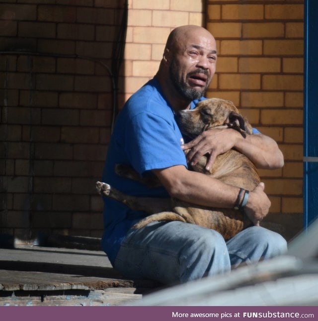 Man holds his dog that passed away from smoke inhalation