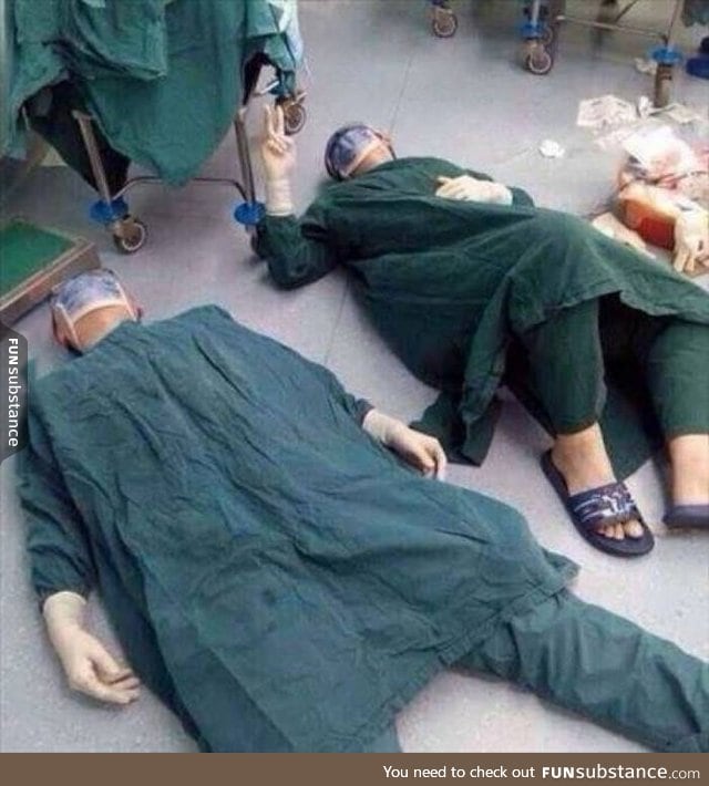 Doctors lying on the floor after a 32-hour brain operation