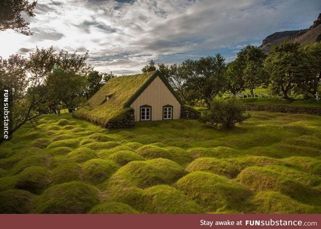 A church in Iceland is made from wood and peat, the humps are very old graves