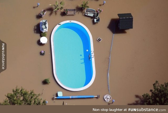 A intact pool between the dirty water of a flood