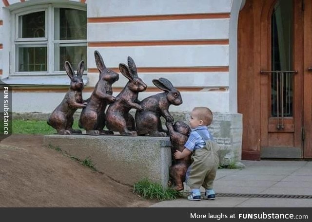 Cute kid trying to help a statue
