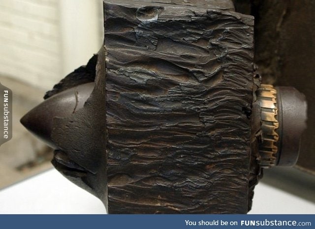 17-pdr gun "armor piercing" shell embedded in a WWII Tiger I tank armor