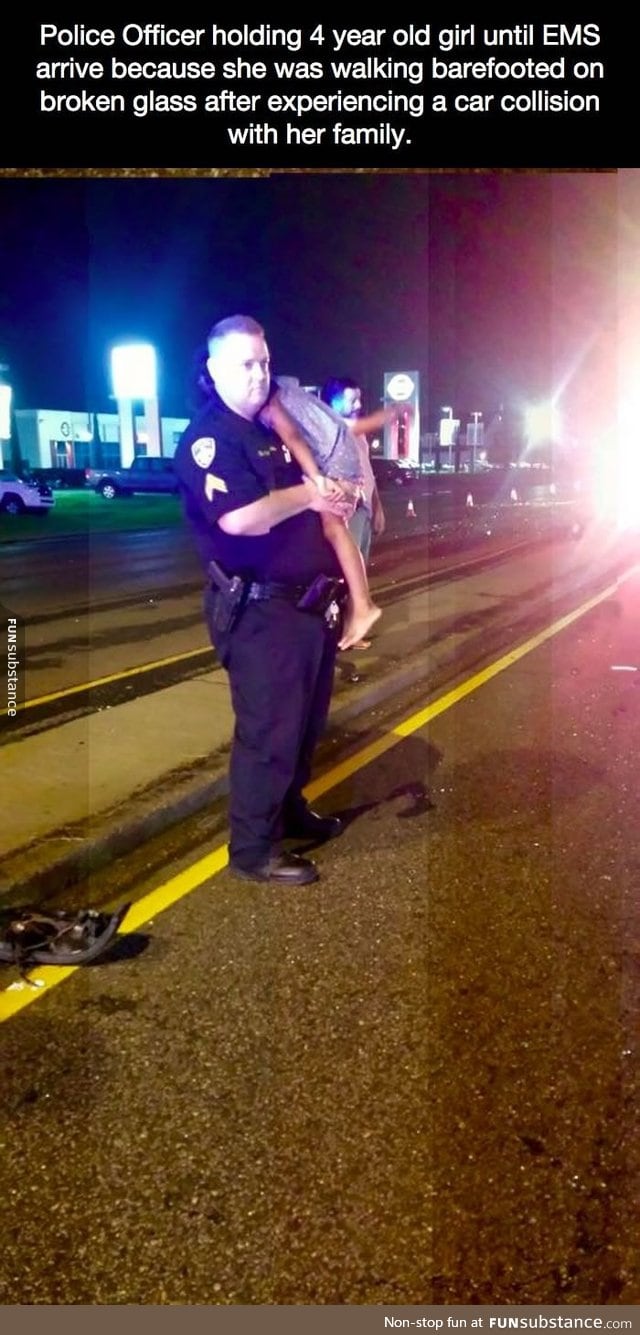 Police Officer holding 4 year old girl until EMS arrive because
