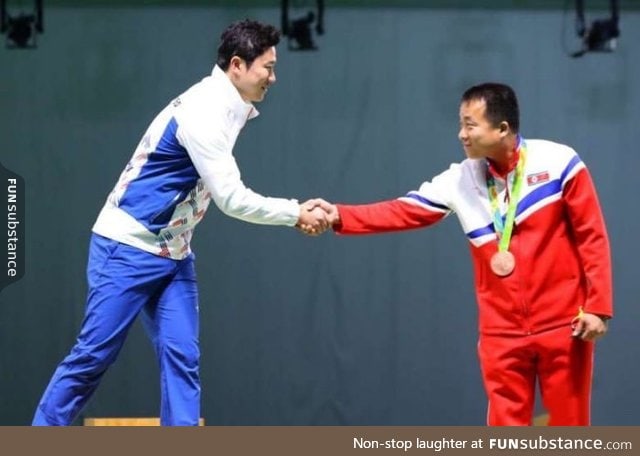 Olympic shooters from both Koreas shakes hands during the medal ceremony