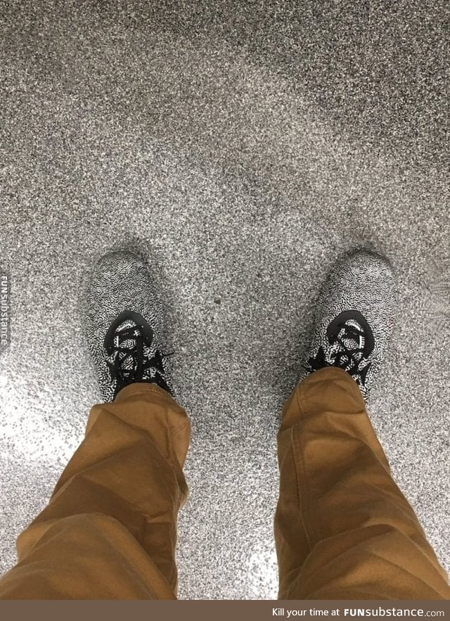 Shoes blend in with a public toilet floor