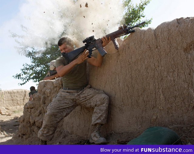 A US Marine has a close call fighting the Taliban