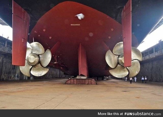 Aircraft carrier propellers with humans for scale
