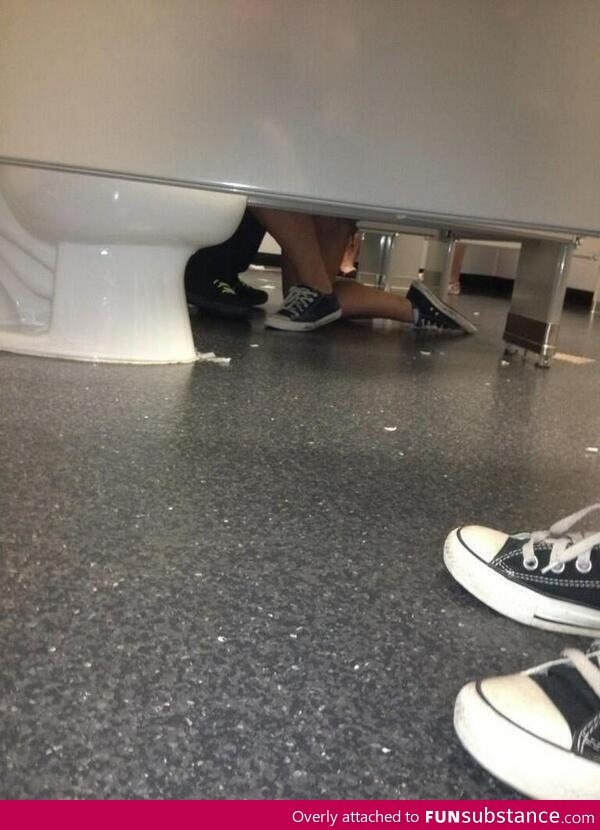 Aww, there's a girl proposing to a guy in the bathroom!