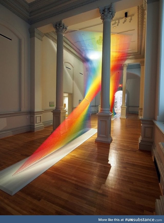 Vibrant rainbow installation made with 60 miles of thread weaves