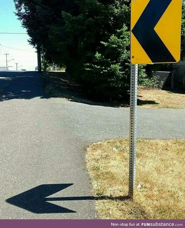 The shadow of this sign creates an arrow to the same direction