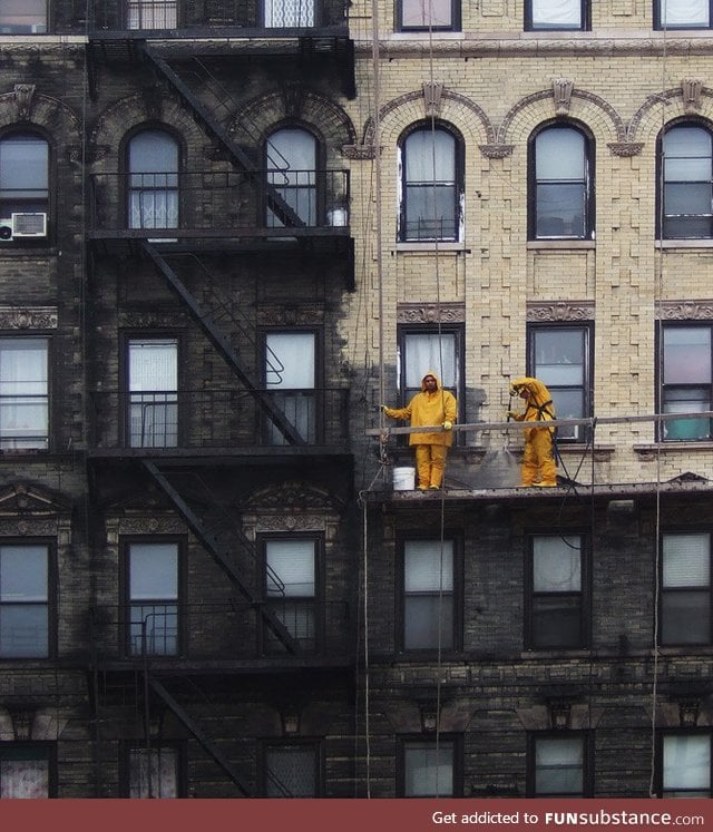 A building in New York City getting power washed and having years of grime removed