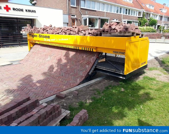 Brick laying road machine
