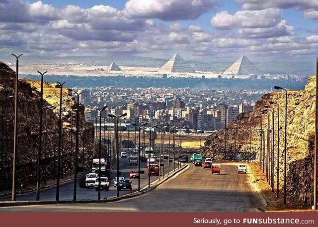The great pyramids of Giza as seen from a street in Cairo