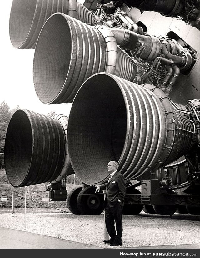 Wernher von Braun standing next to the F-1 engines of the Saturn V