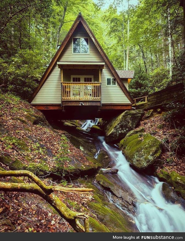 A-frame cabin built over a creek