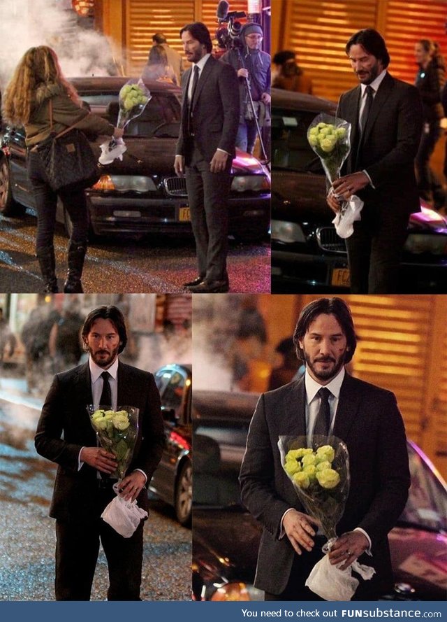 Keanu Reeves getting flowers from a fan