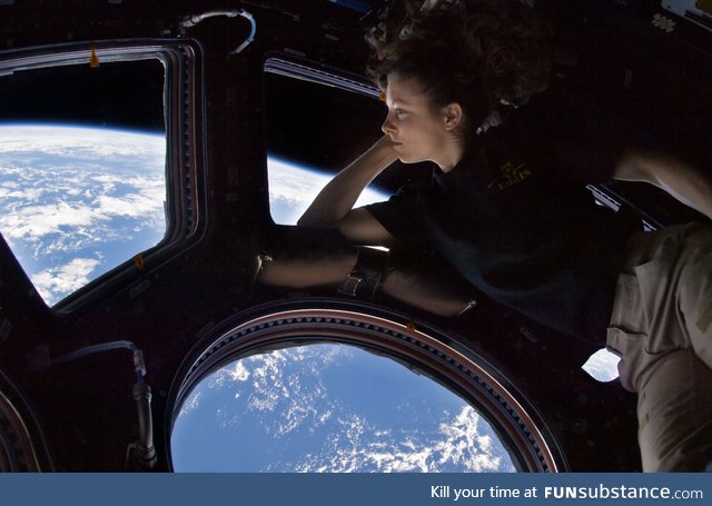 Astronaut Tracy Caldwell Dyson looking down at Earth from the ISS, 2010