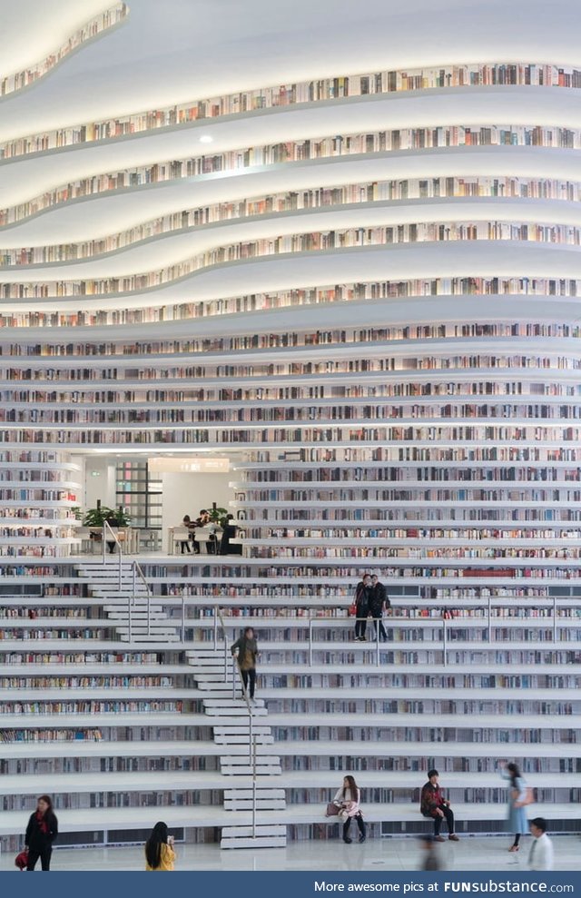Tianjin Binhai Library in China incorporates bookshelves into the stairs and seating to