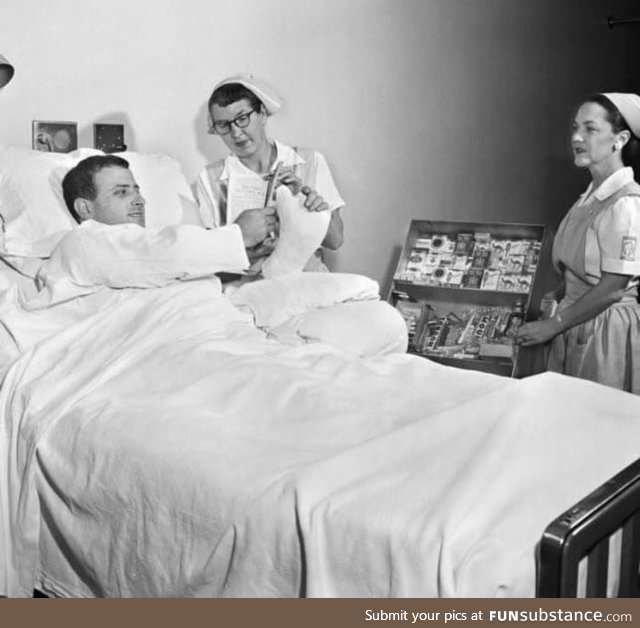 A man buying cigarettes from his hospital bed , 1950s