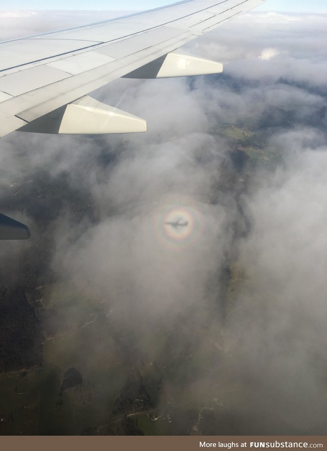 This rainbow around the airplane’s shadow