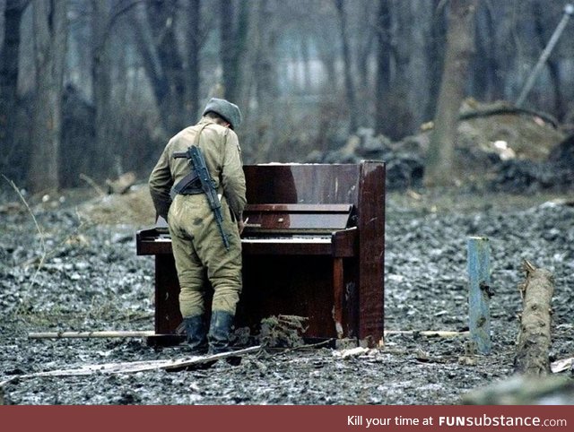 Russian soldier playing an abandoned piano in Chechnya, 1994