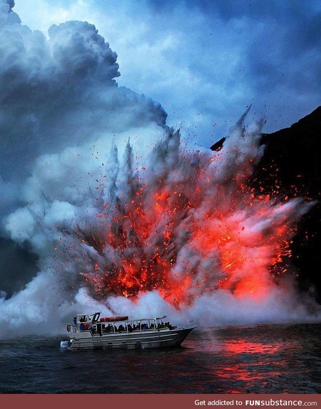 Lava exploding next to a tourist boat
