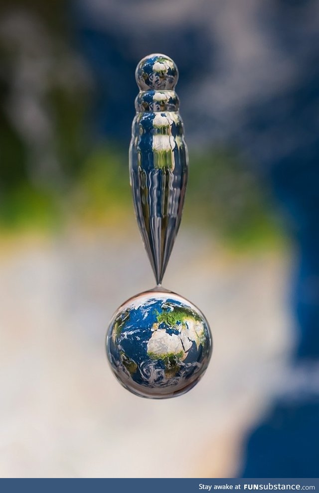 Water droplet captured above map of the earth