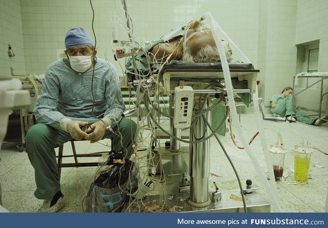 Dr. Zbigniew Religa watching the vital signs of his patient after a 23 hrs long heart