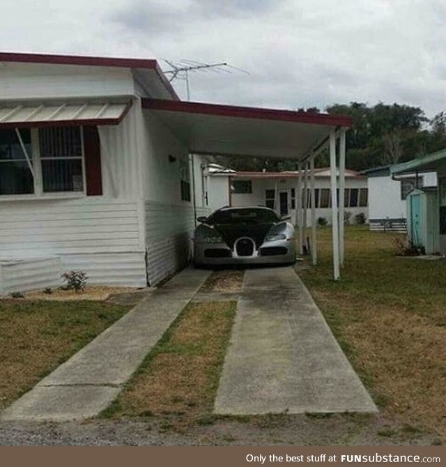 A 2 Million Dollar Bugatti Veyron parked in a mobile home park. This guy either has it