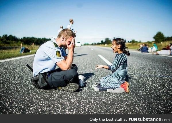 A Danish officer playing with a Syrian refugee