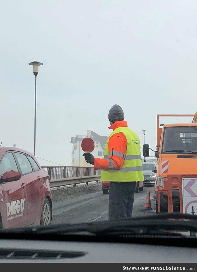 This guy is using a table tennis racket to control the traffic