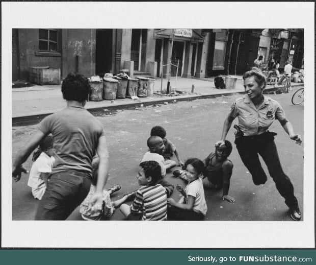 A police officer playing with children in New York, 1970