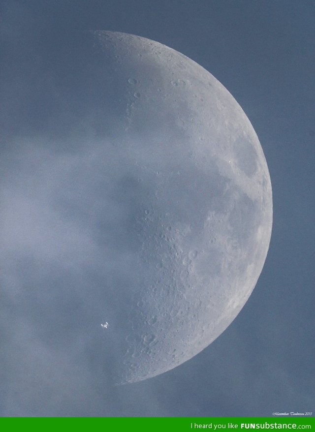 The international space station crosses paths with the moon