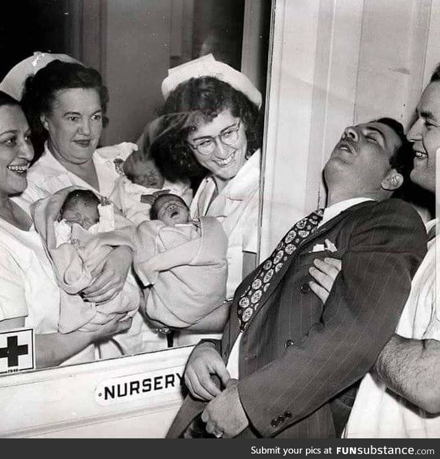 Nurses showing a set of newly born triplets to a surprised father in a New York City