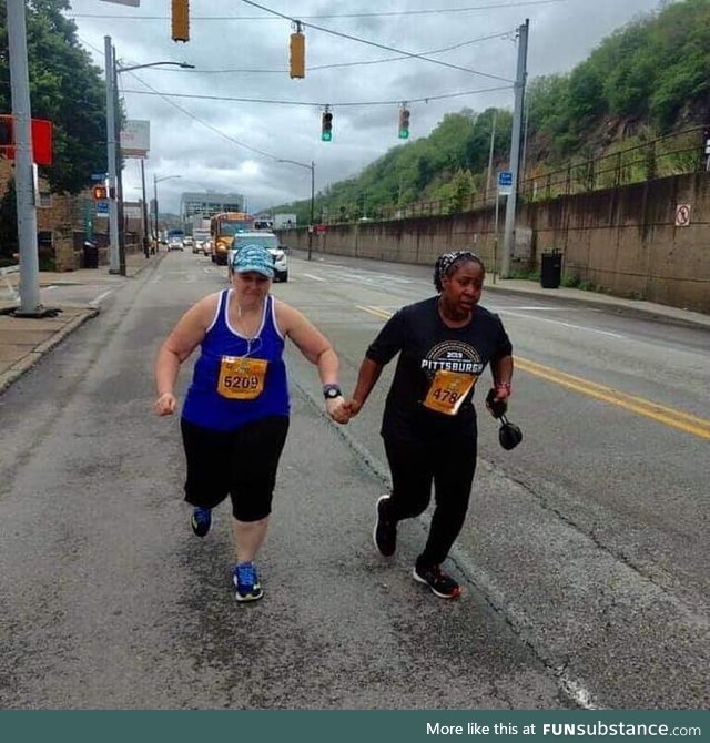 The last two runners of the Pittsburgh Marathon not letting each other quit
