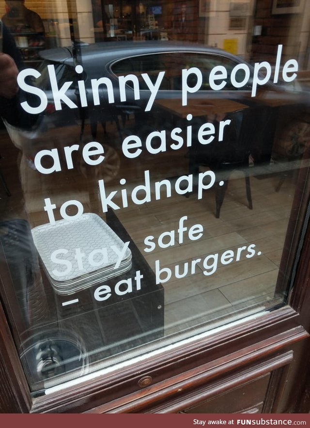 Sign on a window of a burger joint in Krakow, Poland