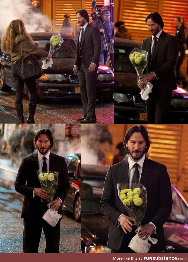 Keanu Reeves getting flowers from a fan on set of John Wick 2