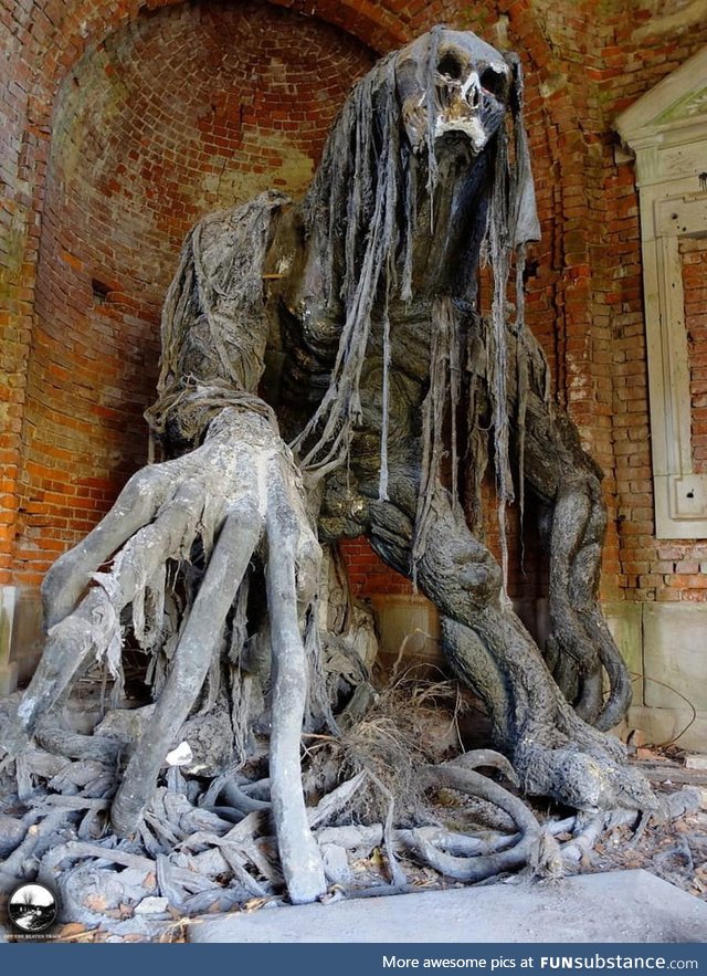Demon statue at an abandoned mausoleum in Poland