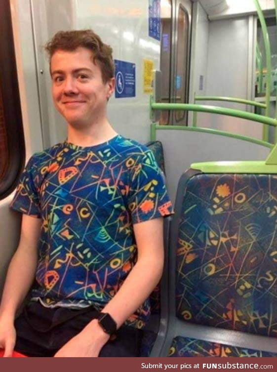 Dude wears a t-shirt identical with the bus seats