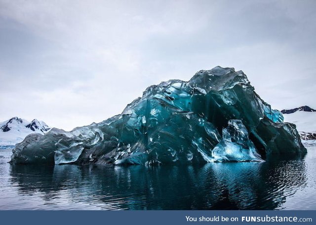 An iceberg flipped over, and its underside is breathtaking