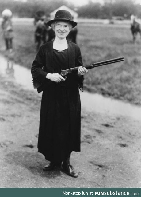 Annie Oakley holding a gun that Buffalo Bill gave her, 1922.