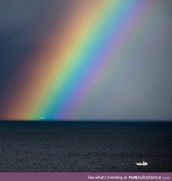 I saw a boat caught in a rainbow