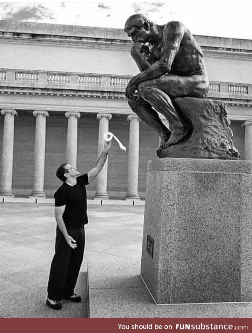 This photo of Robin Williams offering toilet paper to the "thinker" statue