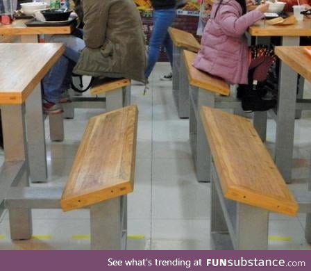 Tilted benches in a food court so customers would leave sooner - literal